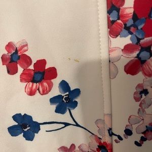 White and floral Tommy Hilfiger dress knee length. Has slight stain